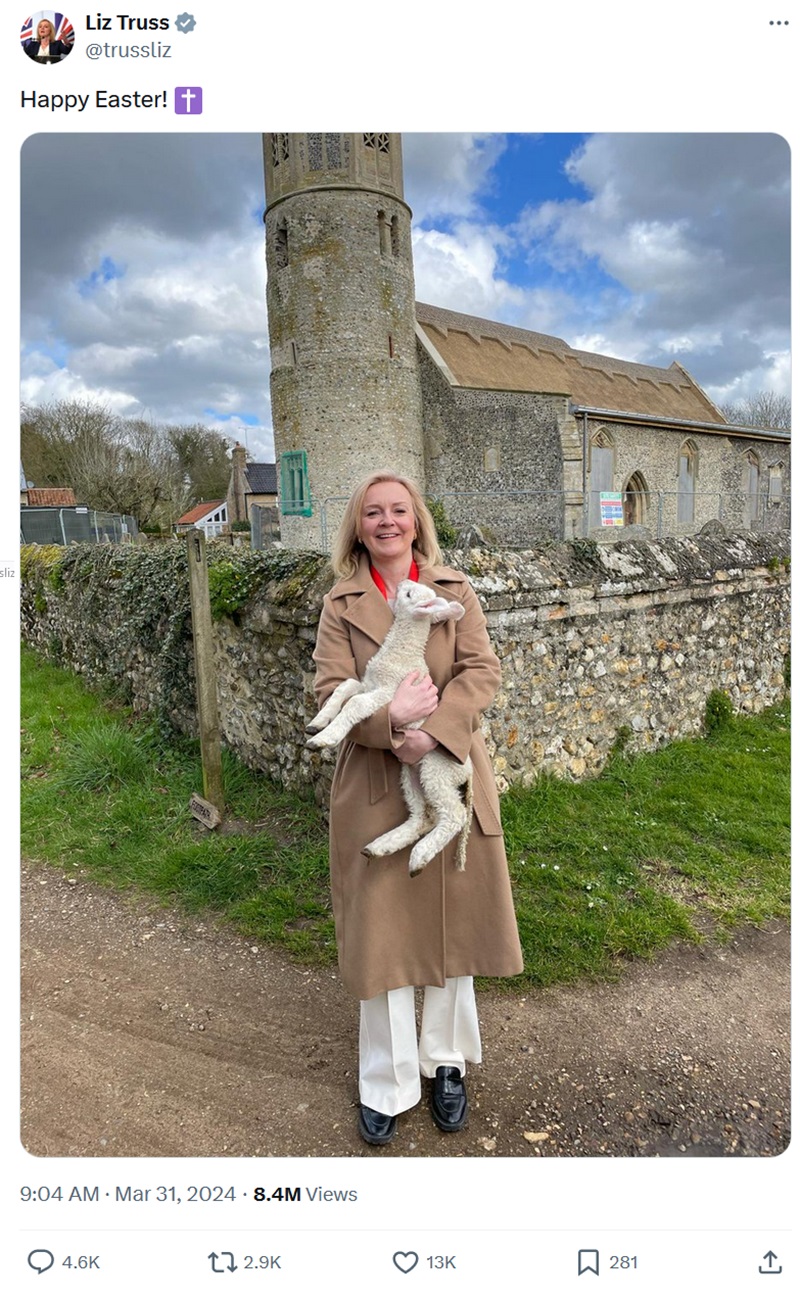 Liz Truss standing in front of a closed-down church, holding a lamb. Text - Happy Easter!